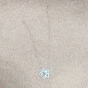 Silver necklace, spells out "Love"